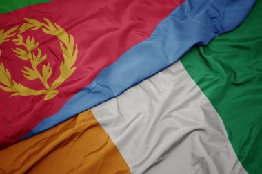 waving colorful flag of cote divoire and national flag of eritrea.
