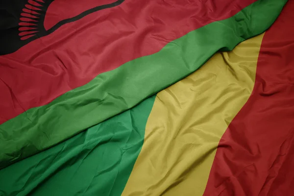 Sventolando bandiera colorata della repubblica del congo e bandiera nazionale del Malawi . — Foto Stock