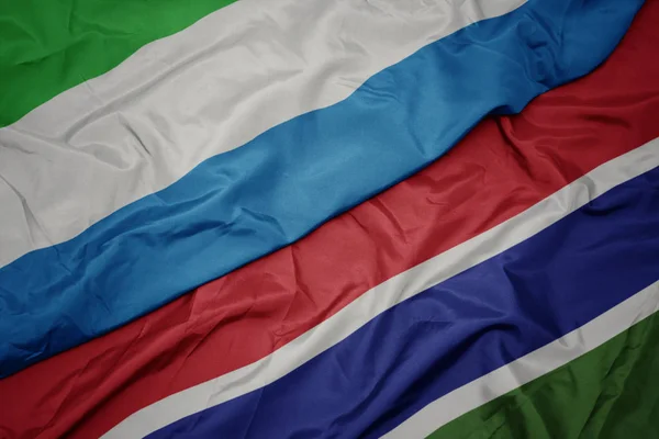 Waving colorful flag of gambia and national flag of sierra leone. — Stock Photo, Image