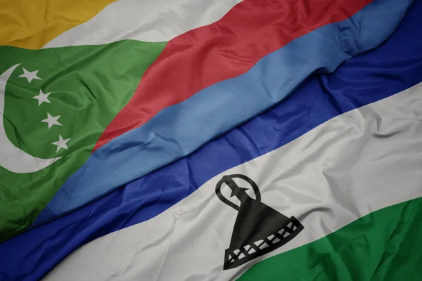Waving colorful flag of lesotho and national flag of comoros. — Stock Photo, Image