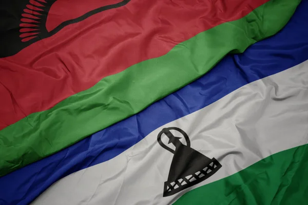 Lesotho 'nun renkli bayrağı ve Malawi' nin ulusal bayrağı sallanıyor.. — Stok fotoğraf