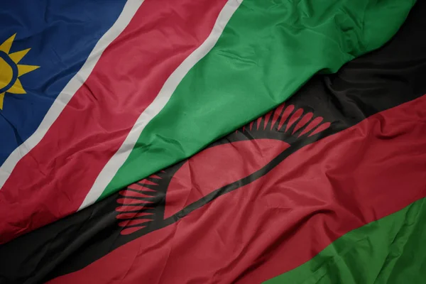 マラウイのカラフルな旗とナミビアの国旗を振って. — ストック写真