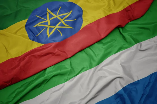 Ondeando colorida bandera de Sierra Leona y bandera nacional de Etiopía  . —  Fotos de Stock