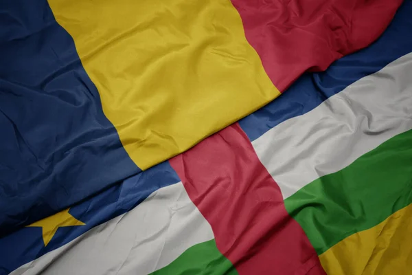 Machanie kolorową flagą Republiki Środkowoafrykańskiej i flagą narodową Czadu. — Zdjęcie stockowe