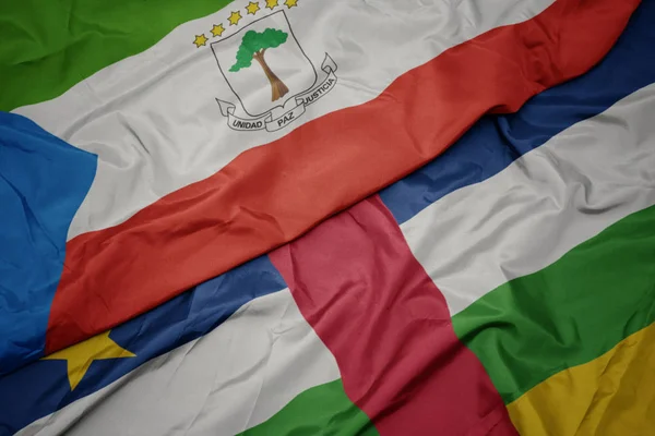 Sventolando bandiera colorata della repubblica centrafricana e bandiera nazionale della Guinea equatoriale . — Foto Stock