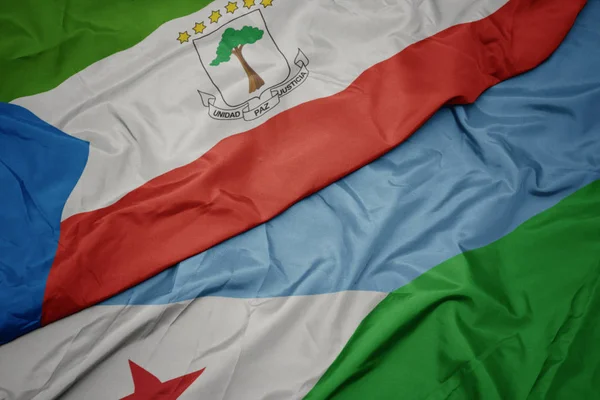 Ondeando colorida bandera de djibouti y bandera nacional de Guinea Ecuatorial . —  Fotos de Stock