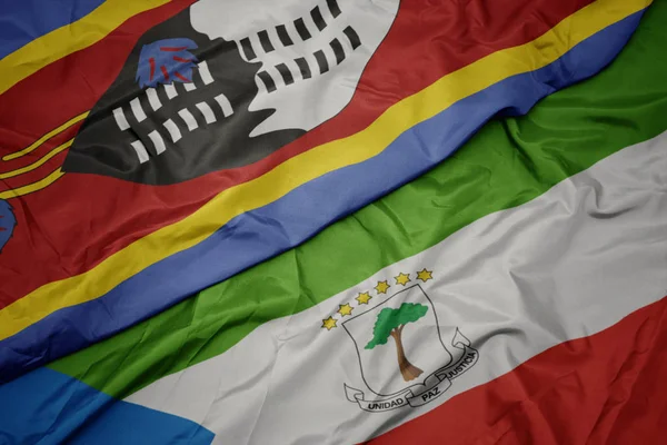 Ondeando colorida bandera de Guinea Ecuatorial y bandera nacional de Swazilandia . —  Fotos de Stock
