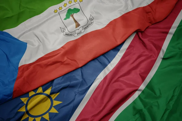 Ondeando colorida bandera de namibia y bandera nacional de Guinea Ecuatorial . —  Fotos de Stock