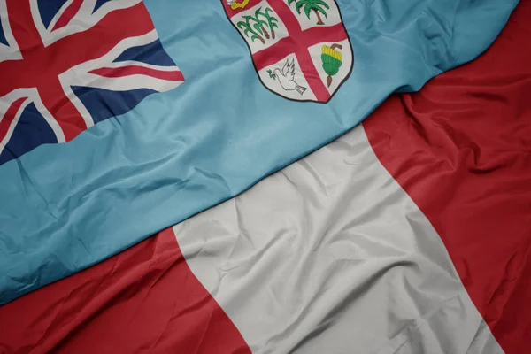 Waving colorful flag of peru and national flag of Fiji . — Stock Photo, Image