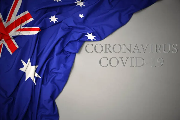 Australias Flagg Viftes Med Tekst Coronavirus Covid Grå Bakgrunn – stockfoto