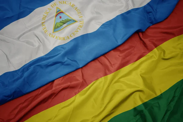 ボリビアのカラフルな旗とニカラグアの国旗を振っています マクロ — ストック写真