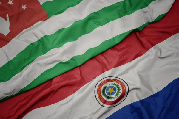 Machając Barwną Flagą Paragwaju Narodową Flagą Abchazji Makro — Zdjęcie stockowe