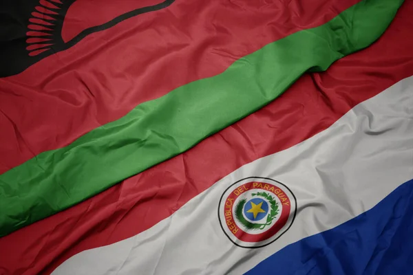 Machając Barwną Flagą Paragwaju Flagą Narodową Malawi Makro — Zdjęcie stockowe