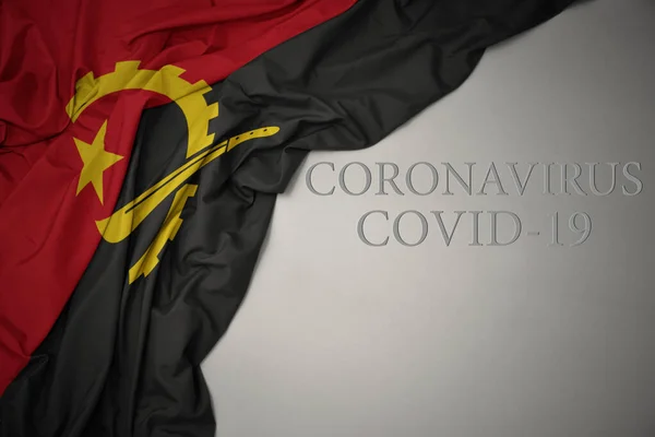 Schwenken Bunte Nationalflagge Von Angola Auf Grauem Hintergrund Mit Text — Stockfoto