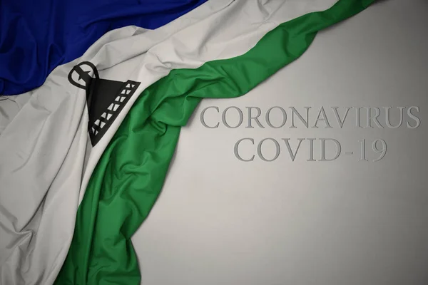 Acenando Colorido Bandeira Nacional Lesotho Fundo Cinza Com Texto Coronavírus — Fotografia de Stock