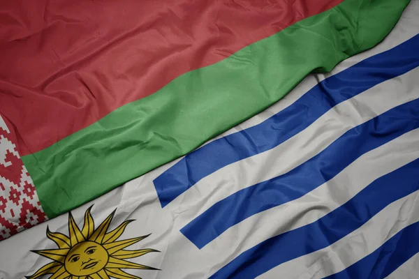 Mávající Barevnou Vlajkou Uruguaye Běloruskou Národní Vlajkou Makro — Stock fotografie