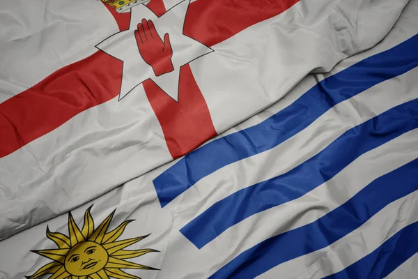 Színes Uruguayi Zászlót Lobogtatva Észak Írország Nemzeti Zászlaját Lobogtatva Makroszintű — Stock Fotó