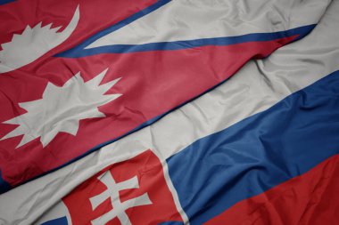 Slovakya 'nın renkli bayrağı ve Nepal' in ulusal bayrağı sallanıyor. makro