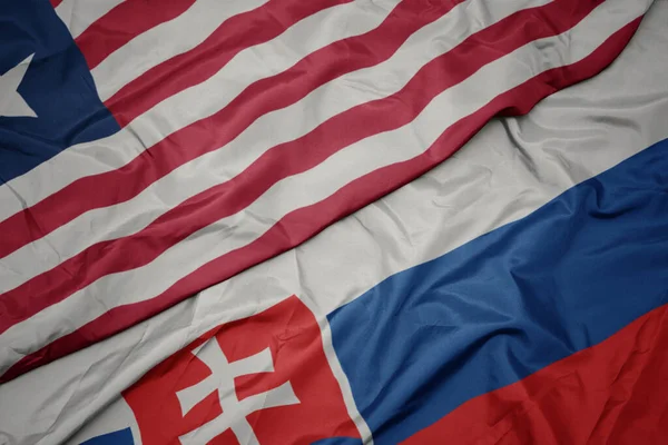 Размахивая Красочным Флагом Словакии Национальным Флагом Либерии Macro — стоковое фото