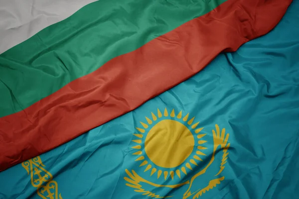 カザフスタンのカラフルな旗とブルガリアの国旗を振っています マクロ — ストック写真