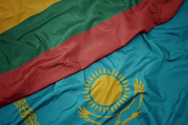 カザフスタンのカラフルな旗とリトアニアの国旗を振っています マクロ — ストック写真