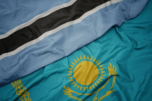 カザフスタンのカラフルな旗とボツワナの国旗を振っています マクロ — ストック写真