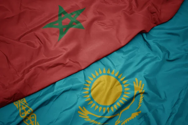 waving colorful flag of kazakhstan and national flag of morocco. macro