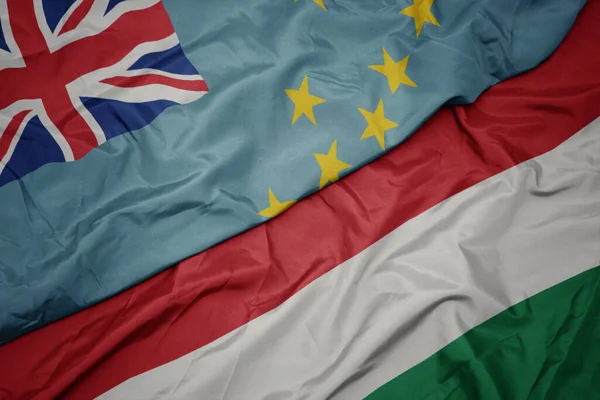 waving colorful flag of hungary and national flag of Tuvalu . macro