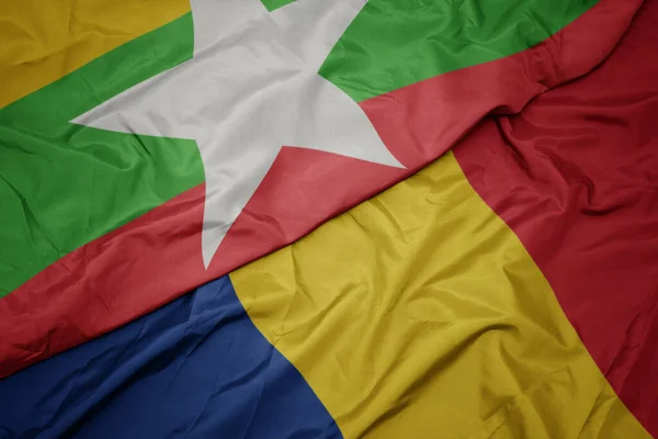 ミャンマーの国旗とルーマニア国旗のカラフルな旗を振っています マクロ — ストック写真