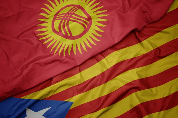 waving colorful flag of catalonia and national flag of kyrgyzstan. macro