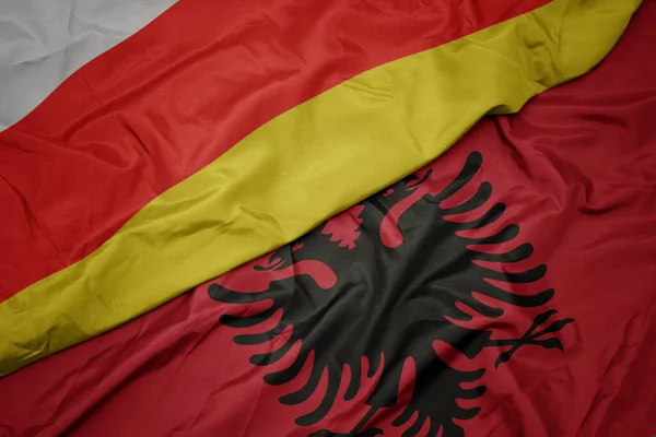 Albania Nın Renkli Bayrağını Güney Osetya Nın Ulusal Bayrağını Sallıyordu — Stok fotoğraf