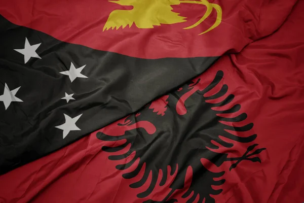 Sventolando Bandiera Colorata Albania Bandiera Nazionale Della Papua Nuova Guinea — Foto Stock