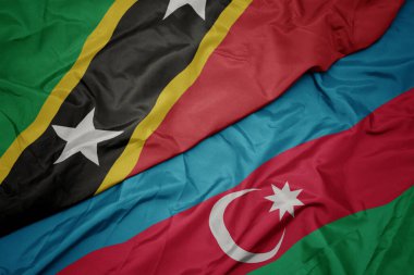Azerbaijan 'ın renkli bayrağını sallıyor ve Azize Kitts ve Nevis' in ulusal bayrağını sallıyor. makro