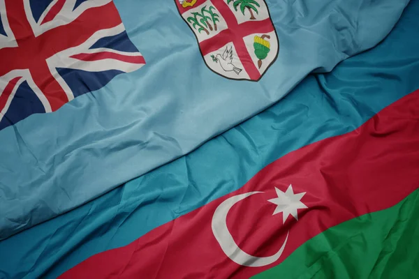 アゼルバイジャンのカラフルな旗とフィジーの国旗を振っています マクロ — ストック写真