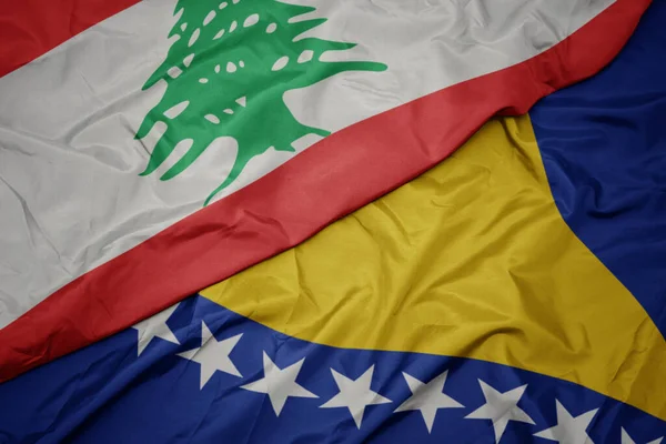 Machając Barwną Flagą Bośni Hercegowiny Oraz Flagą Narodową Libanu Makro — Zdjęcie stockowe