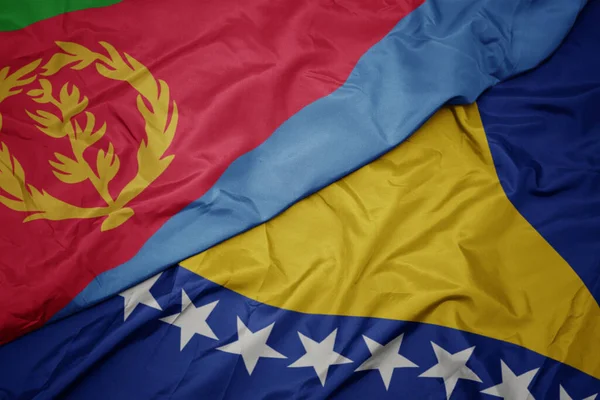 Machając Barwną Flagą Bośni Herzeji Oraz Flagą Narodową Erytrei Makro — Zdjęcie stockowe