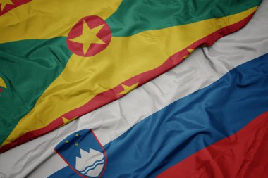 Slovenia 'nın renkli bayrağı ve Grenada' nın ulusal bayrağı sallanıyor. makro