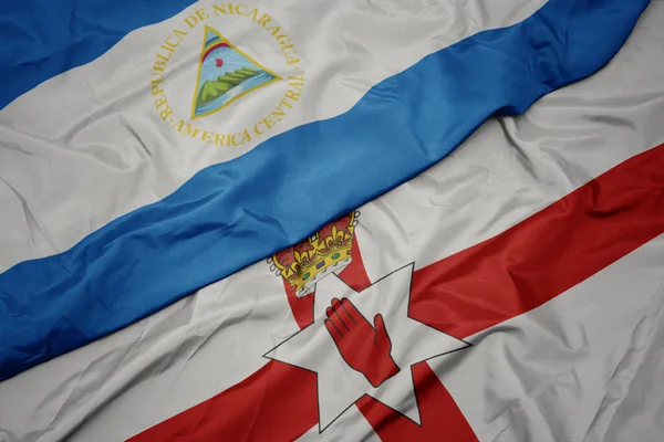 Viftande Färgglada Flagga Norra Irland Och Nationell Flagga Nicaragua Makro — Stockfoto