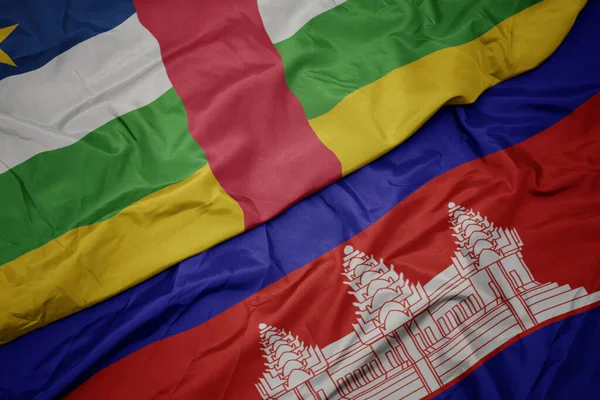 waving colorful flag of cambodia and national flag of central african republic. macro