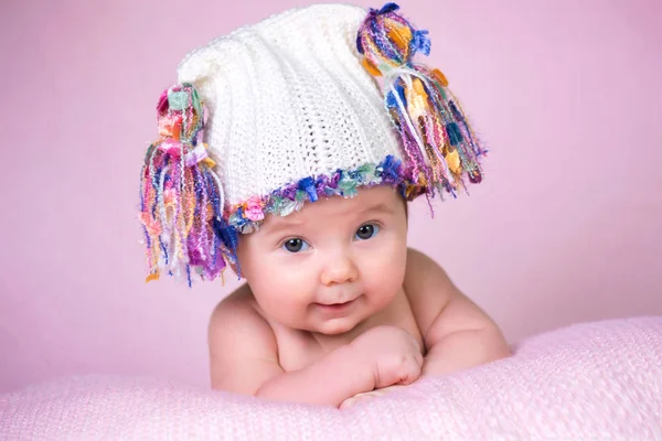 Beautiful little baby girl wearing pink knitted cap — Stock Photo, Image