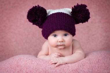 Newborn baby in a warm knitted hat. clipart