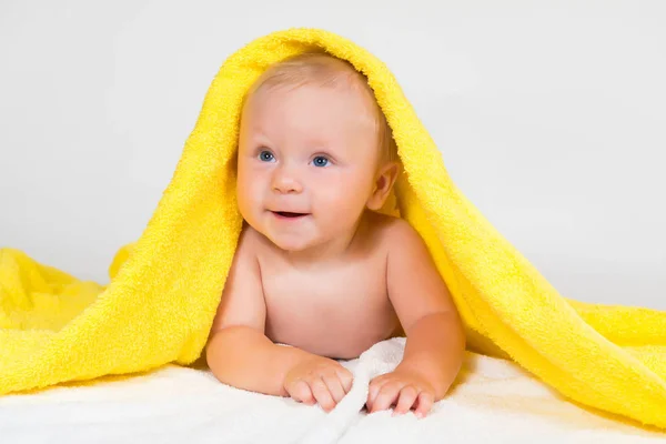 Adorable happy blue-eyed baby in colorful towel — Stock Photo, Image