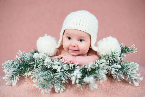 Bebê recém-nascido em um boné de malha. Fundo de neve . — Fotografia de Stock