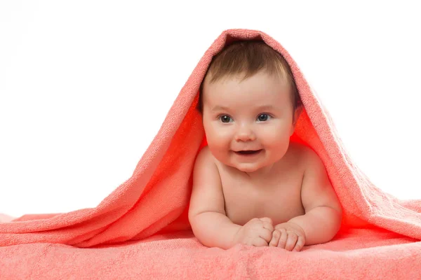 Newborn baby lying down and smiling in a terracotta color towel — Stock Photo, Image