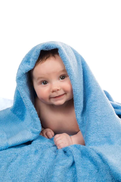 Pasgeboren baby liggend en lachend in een blauwe handdoek — Stockfoto