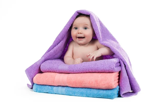 Newborn baby lying on a stack of towels Stock Photo