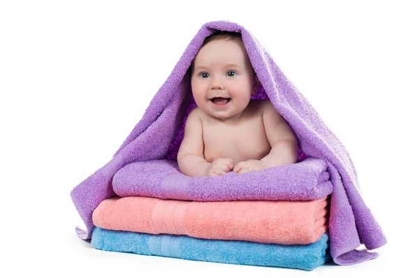 Newborn baby lying on a stack of towels Stock Image
