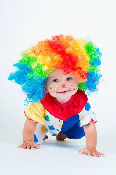 Child clown with a red nose multicolored wig in with balls — Stock Photo, Image