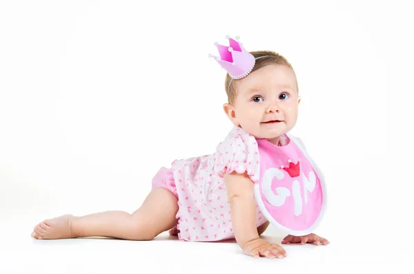 Girl with a crown, sitting in a bib on a white background. — Stock Photo, Image