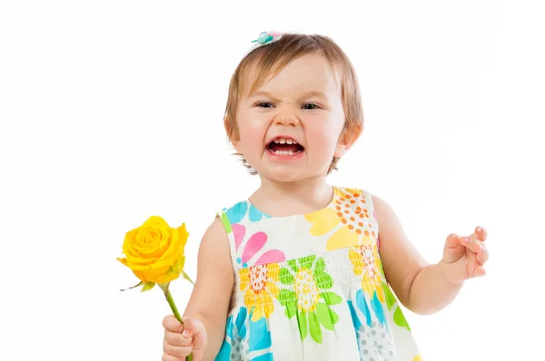 Indignant little girl with a yellow rose, romantic gift — Stock Photo, Image